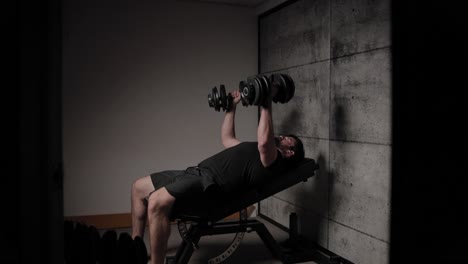 incline dumbbell chest fly, cinematic lighting, white man dressed in black gym attire