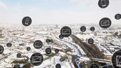 Animation-of-network-of-digital-icons-against-aerial-view-of-winter-landscape