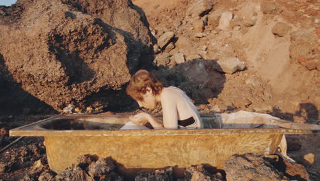 woman in bathtub posing for camera in dystopian world