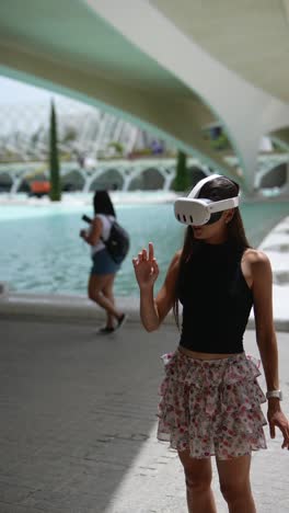 woman wearing vr headset in a city park