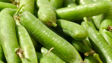 fresh green peas and pods arranged beautifully on a wooden table for a rustic touch freshly harvested green peas and their pods are displayed in beautiful wooden bowls on a rustic outdoor table