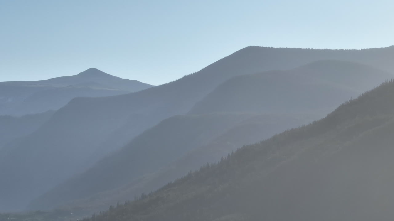 Telephoto drone shot of the Rocky Mountains in Grand Lake, Colorado at sunrise