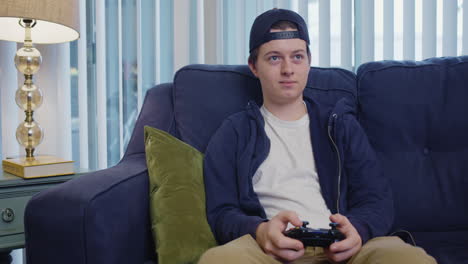 young man is disappointed while playing video games