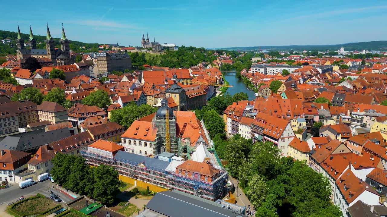 4K Aerial Drone Video of Construction Cranes near the Bamberg Cathedral and Michaelsberg Abbey along the Regnitz River in the Historic Old Town Area of Bamberg, Germany
