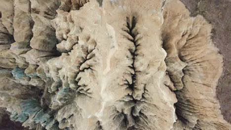 SAND-STONE-CLAY-CLIFFS-ROCK-FORMATION-TOP-DOWN-DRONE-VIDEO