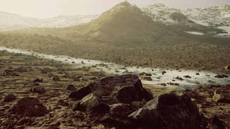 exploring a rocky landscape under a hazy sky with distant mountains