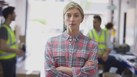 portrait of serious female manager in logistics distribution warehouse