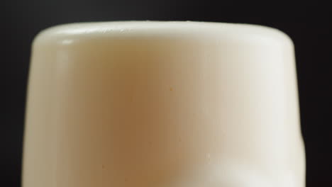close-up of beer glass with frothy head