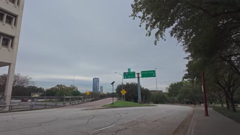 Walking-a-Houston-street-with-road-signs-at-I45-exit