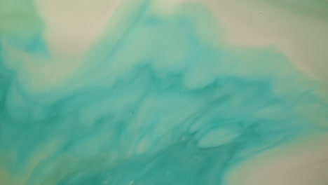 Macro-shot-of-a-turquoise-liquid-moving-on-a-bright-surface