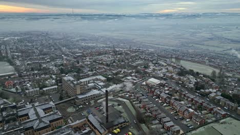 4k cinematic aerial footage, depicting a harsh english uk winter cold spell with mist and freezing temperatures