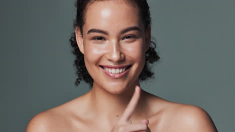 portrait of a woman with finger to lips