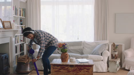 happy young man dancing at home using vacuum cleaner celebrating success listening to music wearing headphones having fun dance in living room on weekend