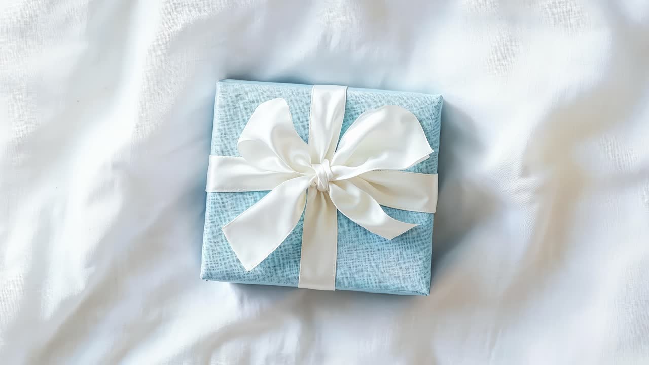 Una scatola regalo blu con un nastro bianco
