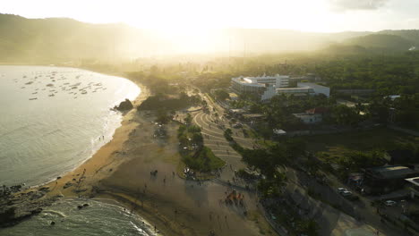 Aerial-circle-of-luxury-hotel-along-coastline-of-Lombok,-sunrise