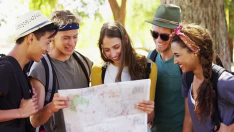 friends looking at map in park 4k