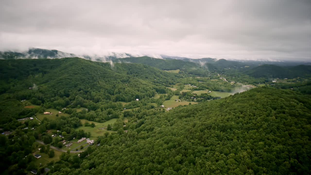 Drone footage flying through a tranquil, fog-soaked Smoky Mountain valley