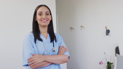 Animation-of-happy-biracial-female-doctor-looking-at-camera