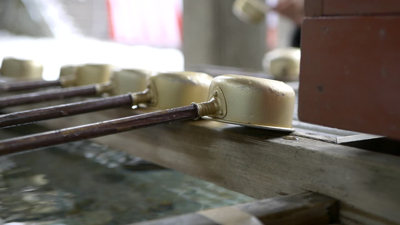 Golden ladles adorn the sacred basin Omizuya, Water Purification Building Toshogu Temple