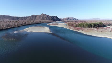 aerial view of a river winding through a mountain valley