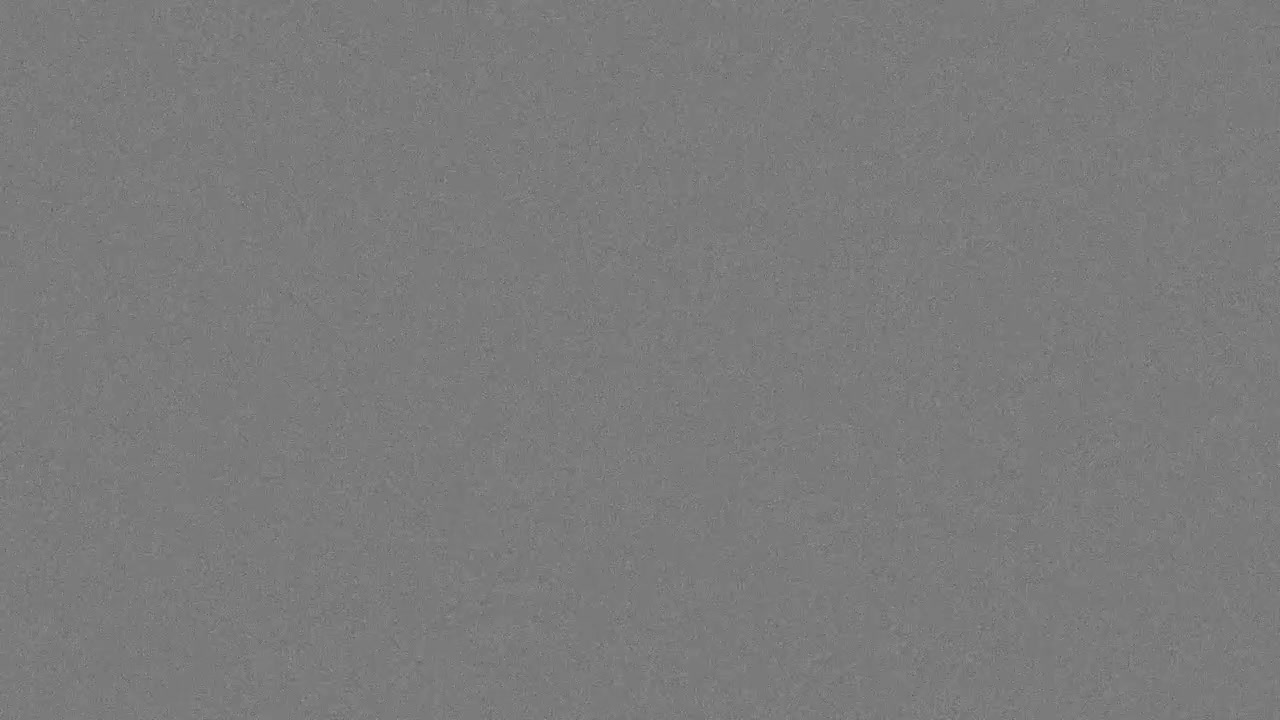 35mm analog film grain texture overlay with subtle noise on gray background, seamless loop