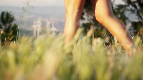 slow-motion-low-shot-of-a-models-stunning-legs-walking-though-long-grass