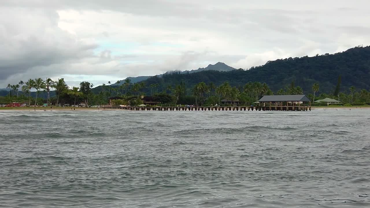 HD 120fps Hawaii Kauai Boating on the ocean floating right to left from Hanalei Pier to beach on left