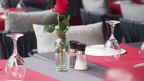 romantic restaurant table setting with red rose