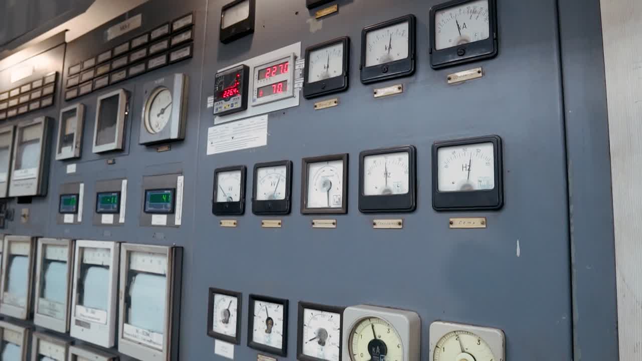 Old electrical console with instruments for controlling a coal-fired power plant. Measurement of current strength, voltage, frequency in the electrical network