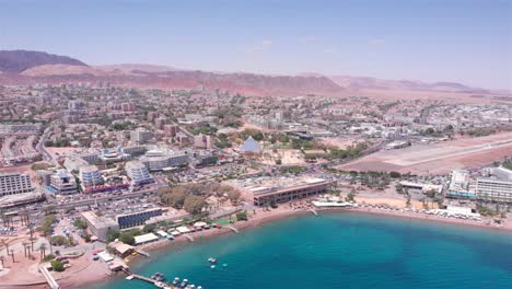 aerial view of the coastal city of eilat, israel, with its bay, beach, and surrounding desert mountains