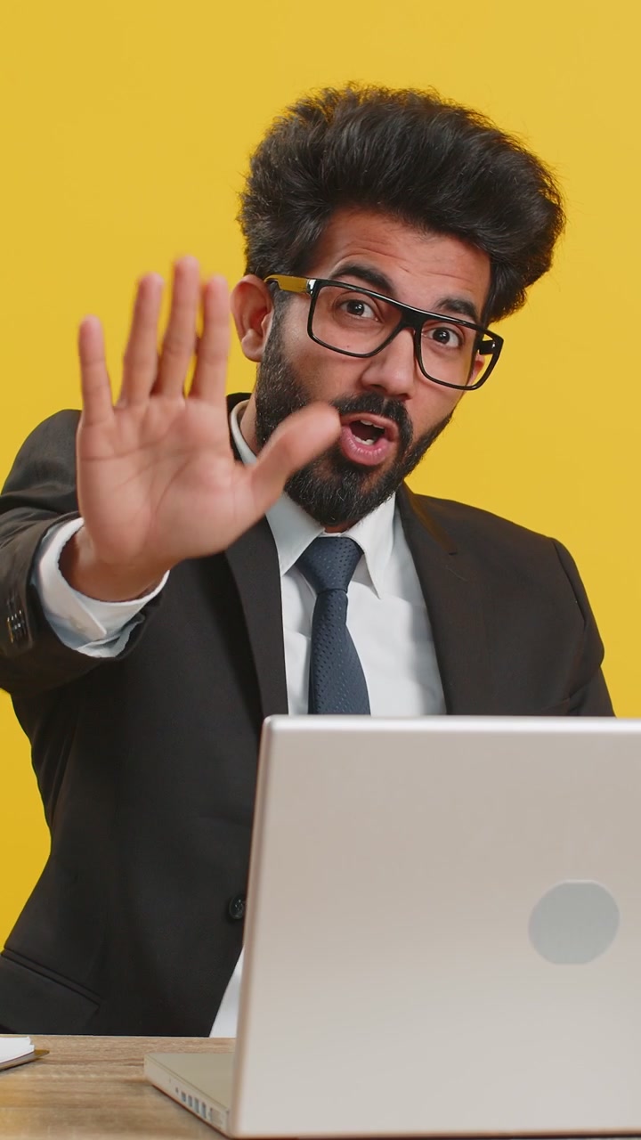 Businessman working on laptop showing stop gestuge danger rejection warning crisis prohibition