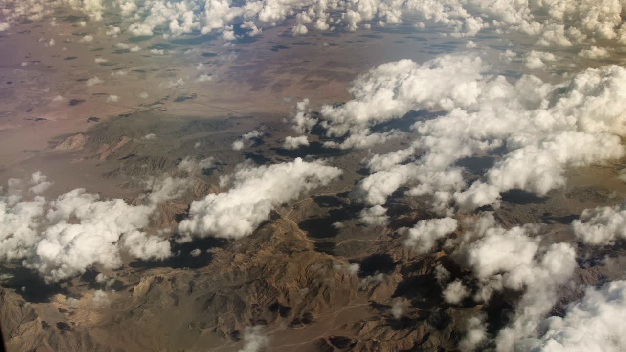 Aerial view from airplane of snow covered Iran mountain landscape in middle east.