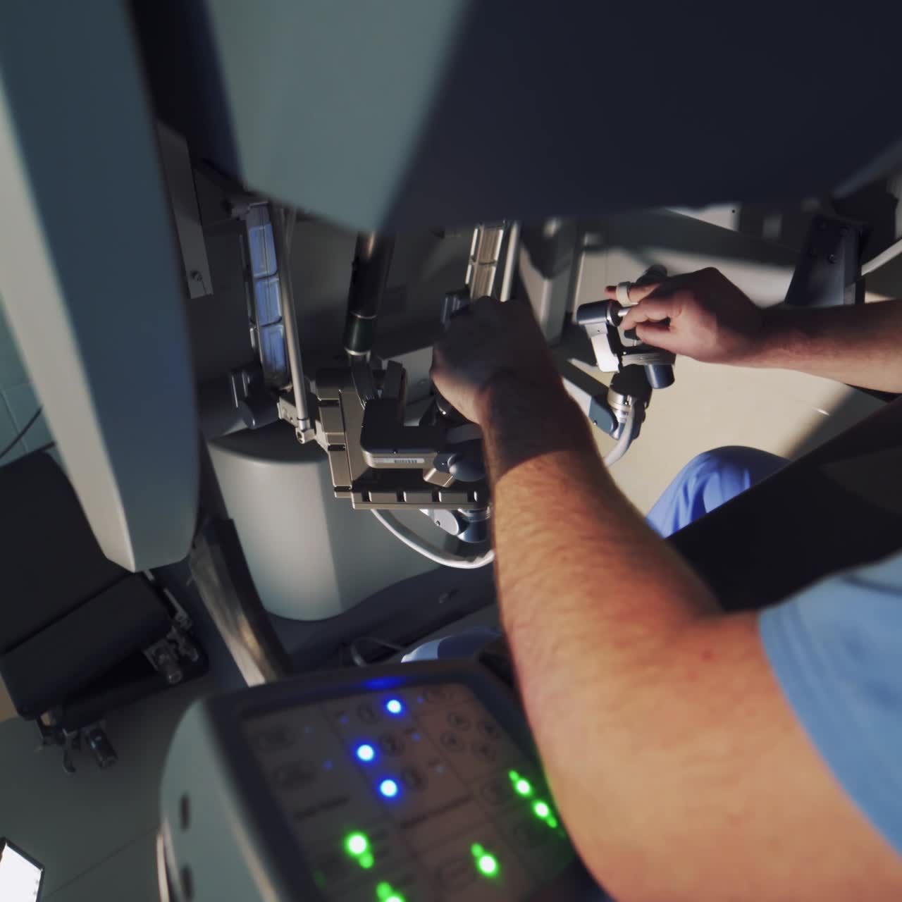 Doctor controls the work of surgical robot in hospital. Modern robotic equipment. Specialist operates futuristic surgical machine in operation room. Close-up.