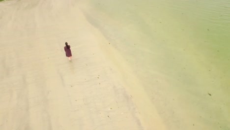 Pretty-woman-walking-on-the-sand