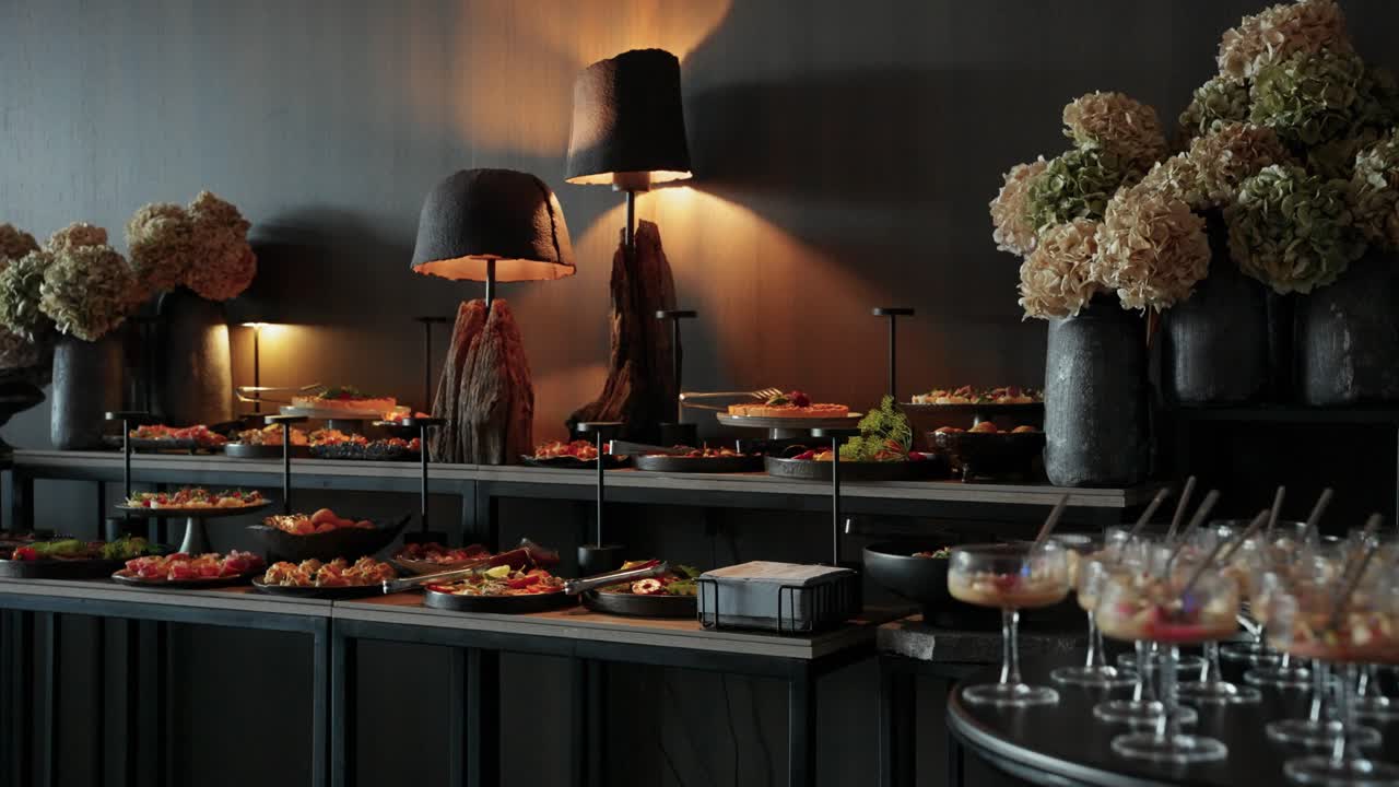 Elegant indoor buffet setup with gourmet appetizers, stylish lighting, and floral decor, ideal for upscale events, parties, or receptions