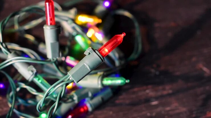 4k close-up of colorful Christmas tree lights on table top blinking