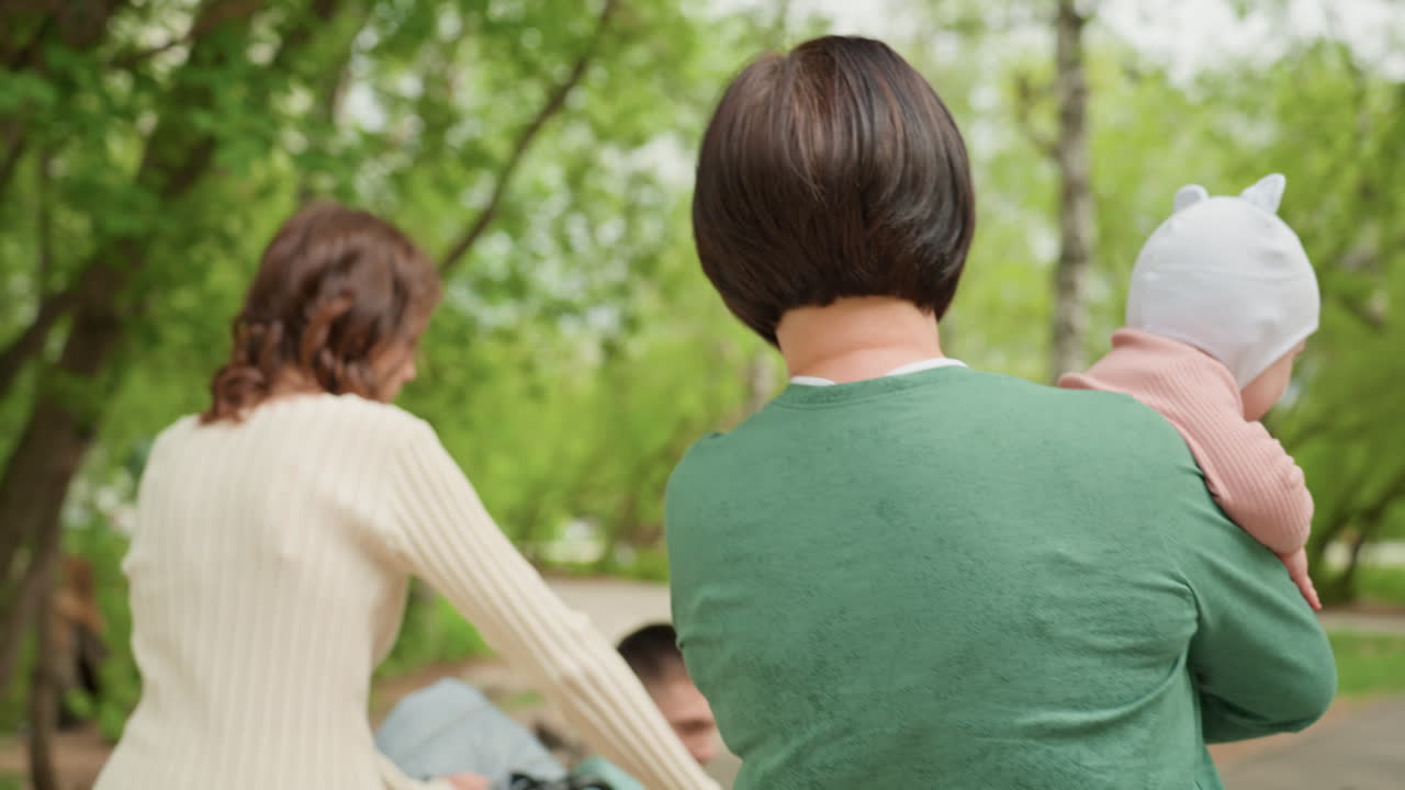 Calm Mother With Child, Gentle Lady Sitting Peacefully With Baby, Quiet Mother Peacefully Bonding With Her Infant Outdoors, Tranquil Woman Enjoying Serene Moment With Her Baby In Park Setting