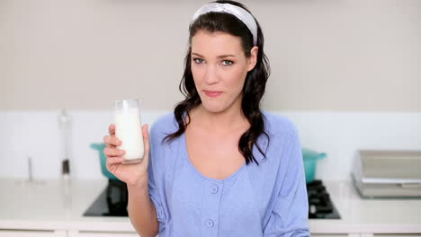 beautiful brunette drinking a glass of milk