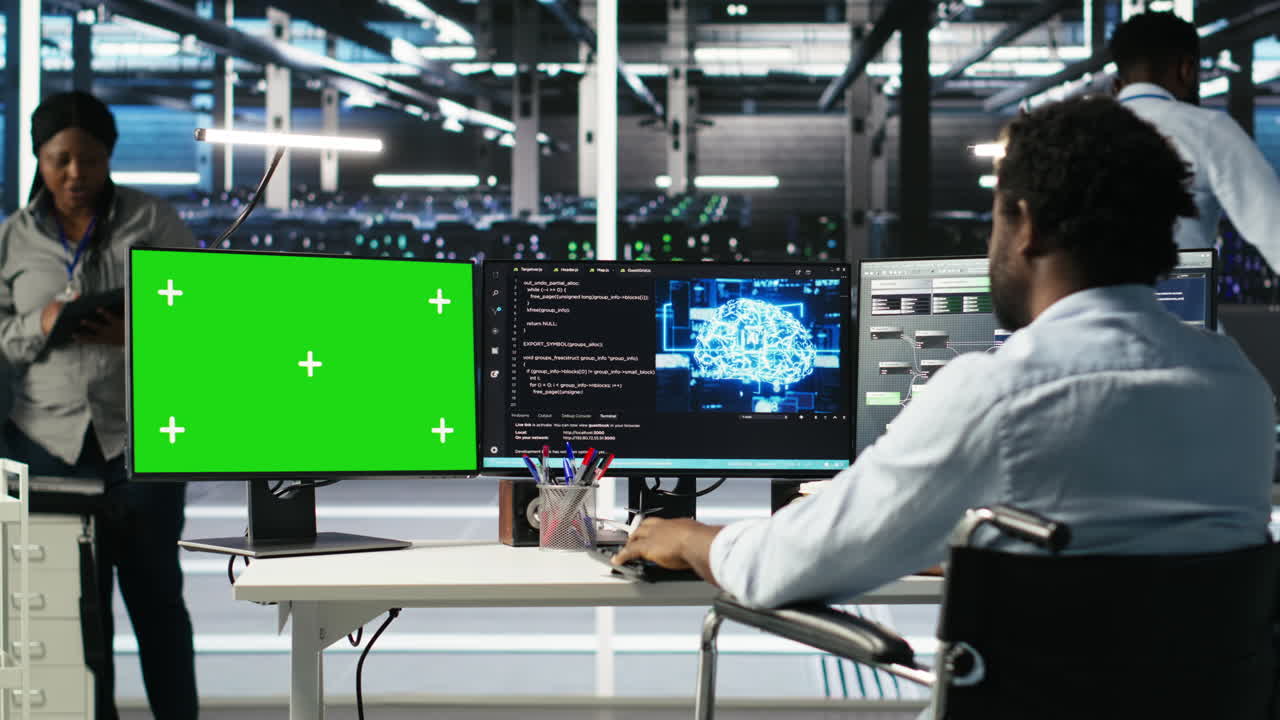 Data center worker with paraplegia using node trees on green screen PC