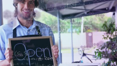 animation of mathematical equations floating over happy caucasian male chef holding open sign