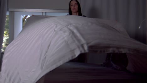 apartment female bedroom, household chores, blanket linens, slow motion