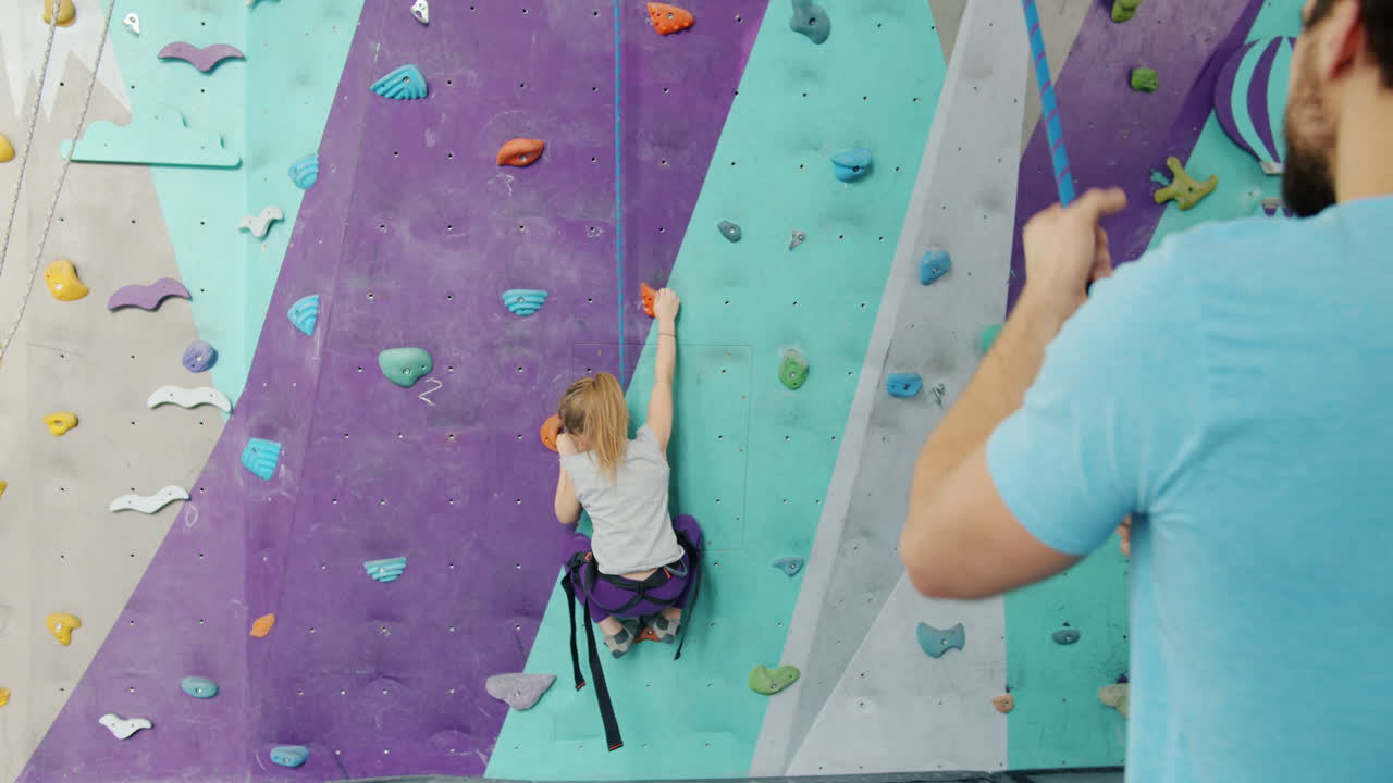 Young Girl Rock Climbing with Instructor