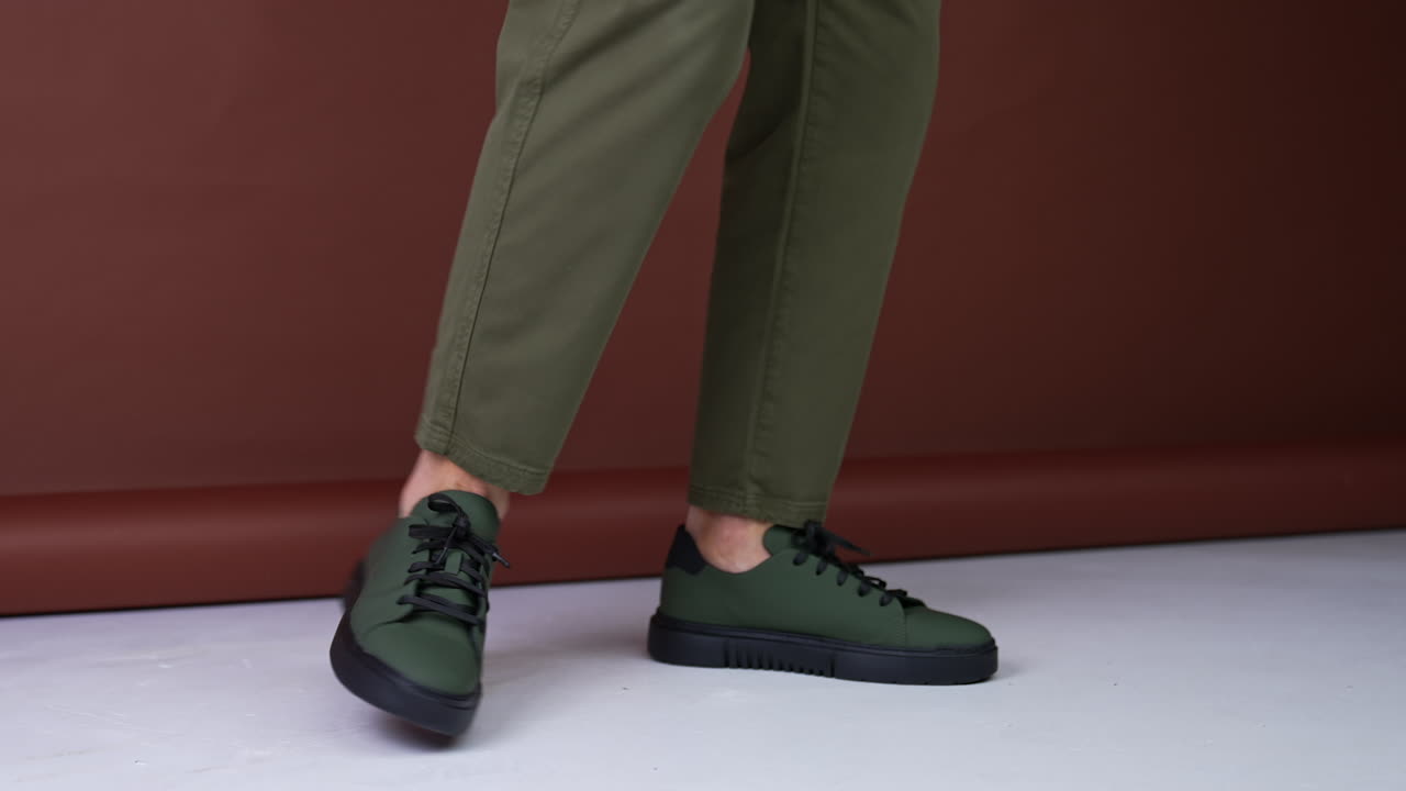 Man Wearing Olive Green Sneakers and Khaki Trousers