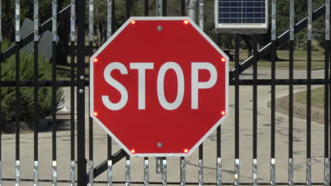 Large-flashing-solar-powered-stop-sign-at-gate----4K