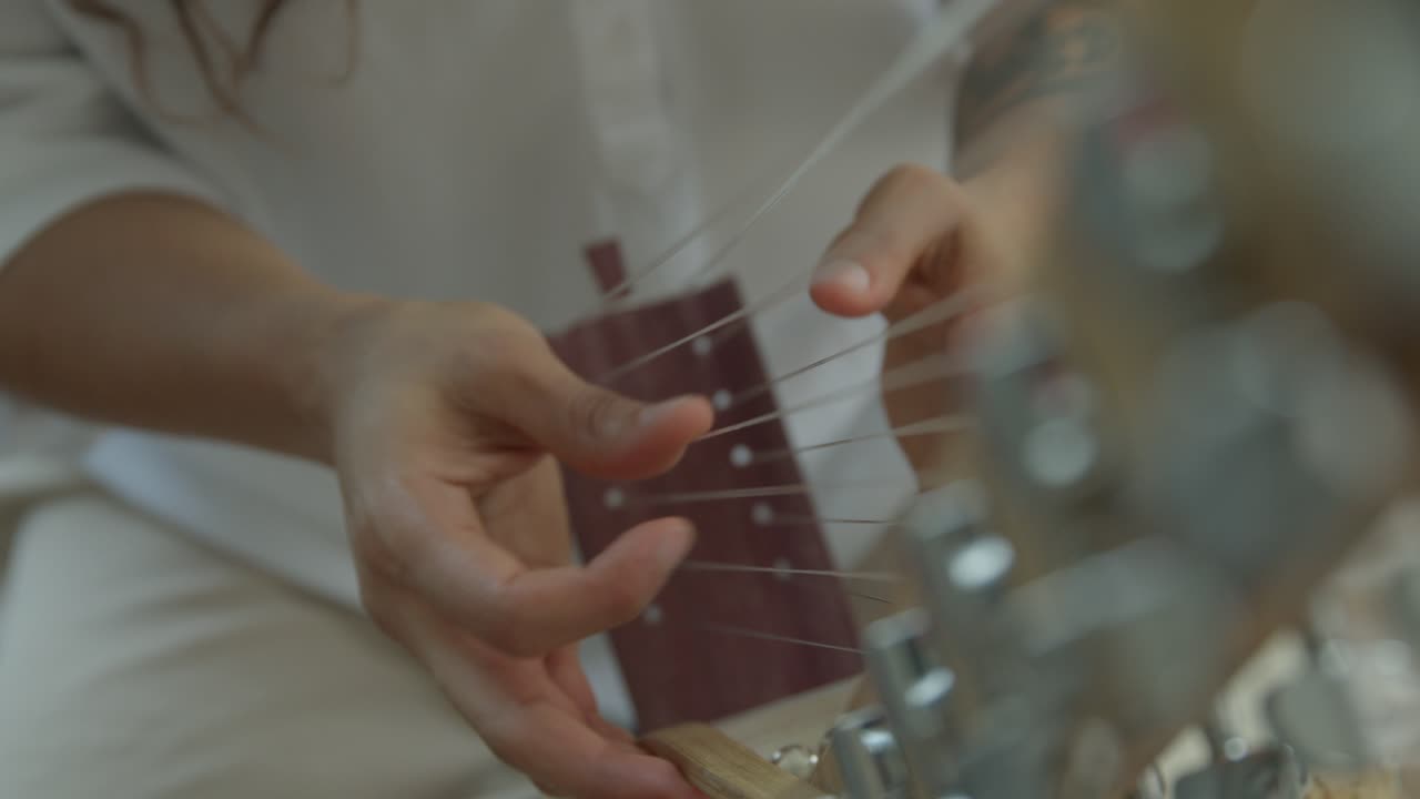 close up on hands while playing Kora strings percussion African harp, close-ups shot