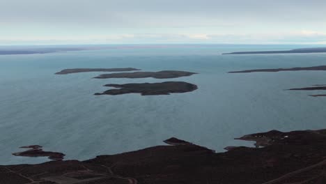 stunning view of the islands and the water of embalse ezequiel ramos mexía, aerial drone footage, copy space and slow motion