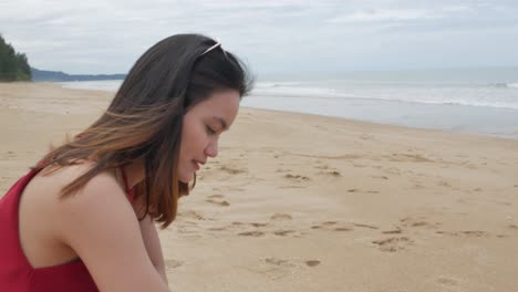 A-young-asian-woman-walk-on-the-beach-and-relax-while-on-holiday-vacation