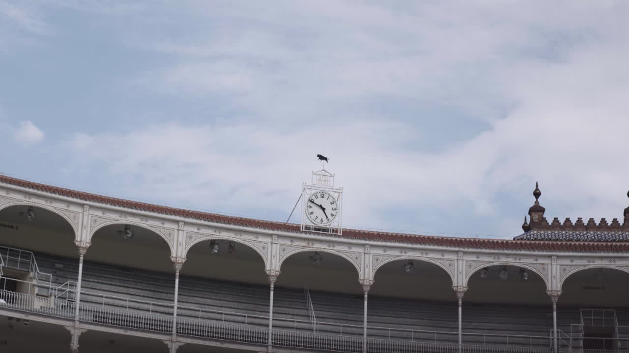 Beautiful slow motion zoom in shot of a large antique clock located at the top of the Las Ventas bullring in Madrid, Spain.
