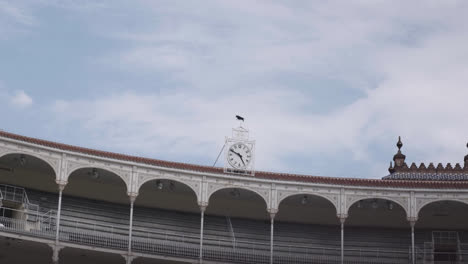 beautiful slow motion zoom in shot of a large antique clock located at the top of the las ventas bullring in madrid, spain.