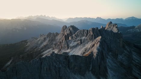 a symphony of light and shadows unfolds across the jagged contours of the catincaccio, captured masterfully from an aerial vantage point